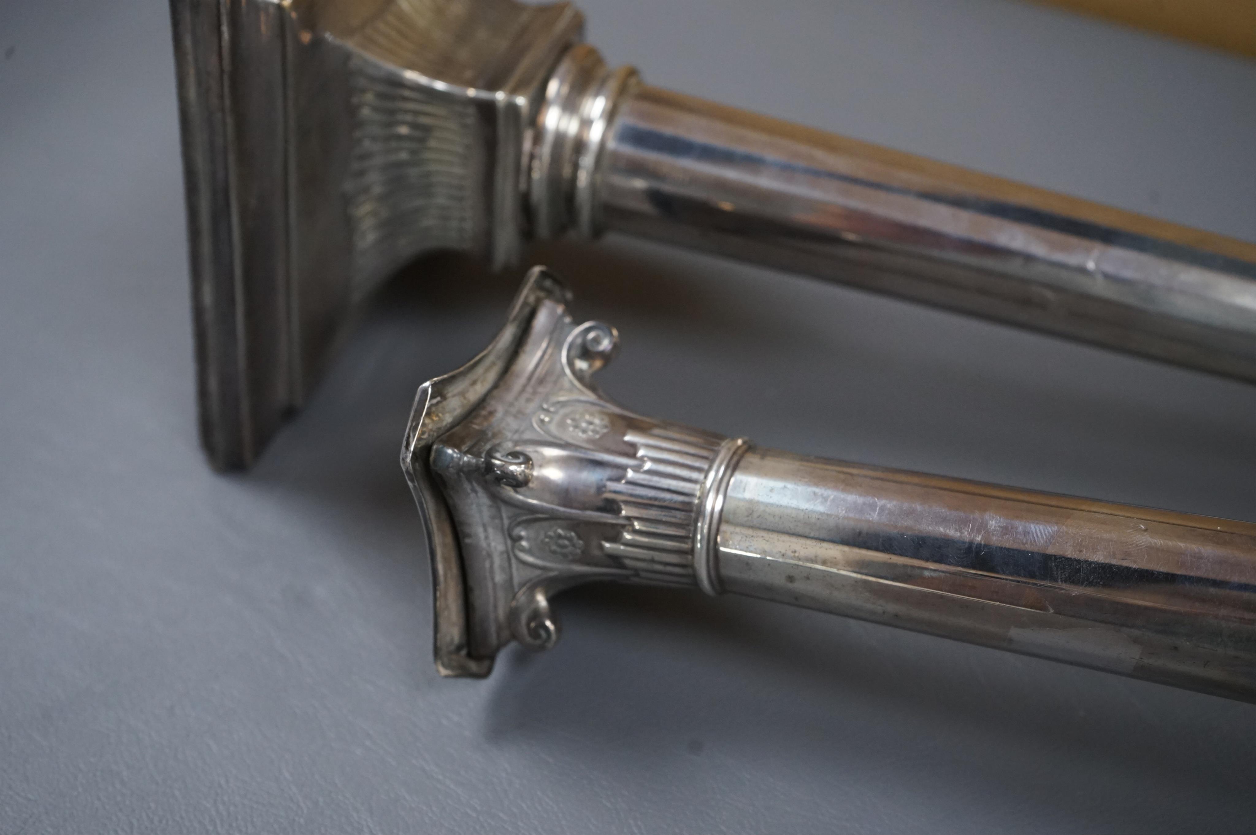 A pair of George III silver candlesticks by Luke Proctor & Co, with panelled stems(worn), on square bases with two engraved armorials, Sheffield, 1786, height 17.4cm, weighted (a.f.).
